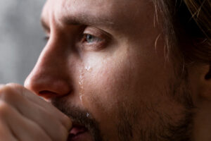 A man with a tear down his face Image by freepik