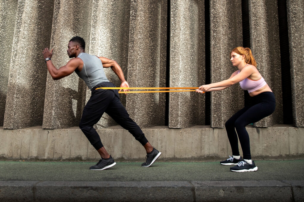 Man & woman doing resistance bands training image by freepik