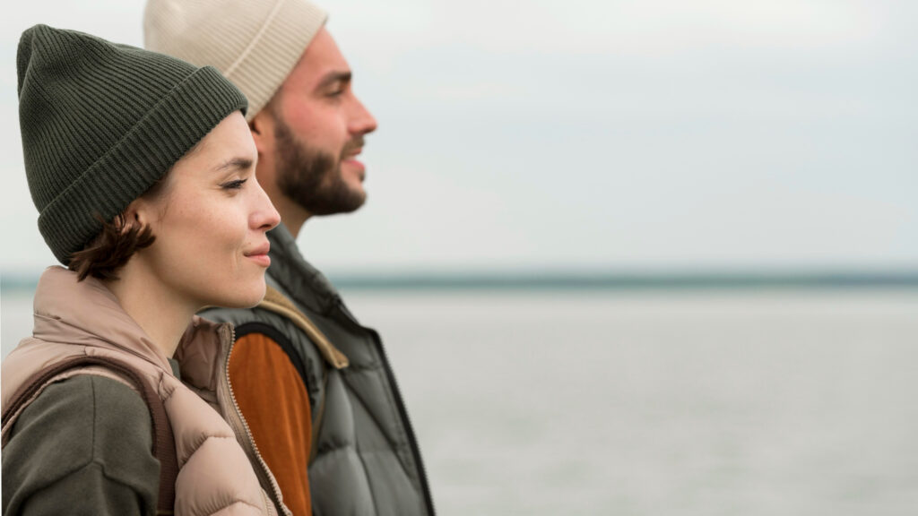 couple in deep thought by lovely water scenery image by freepik