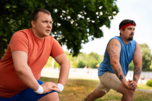 two male friends working out outdoors image by freepik