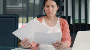 woman reading paper records worried image by tirachardz on freepik