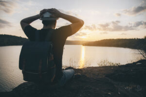 young man with hands on head in sunset scenery image by jcomp on freepik