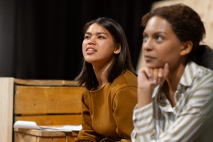 Asian & Black woman observing in lecture setting Image by freepik