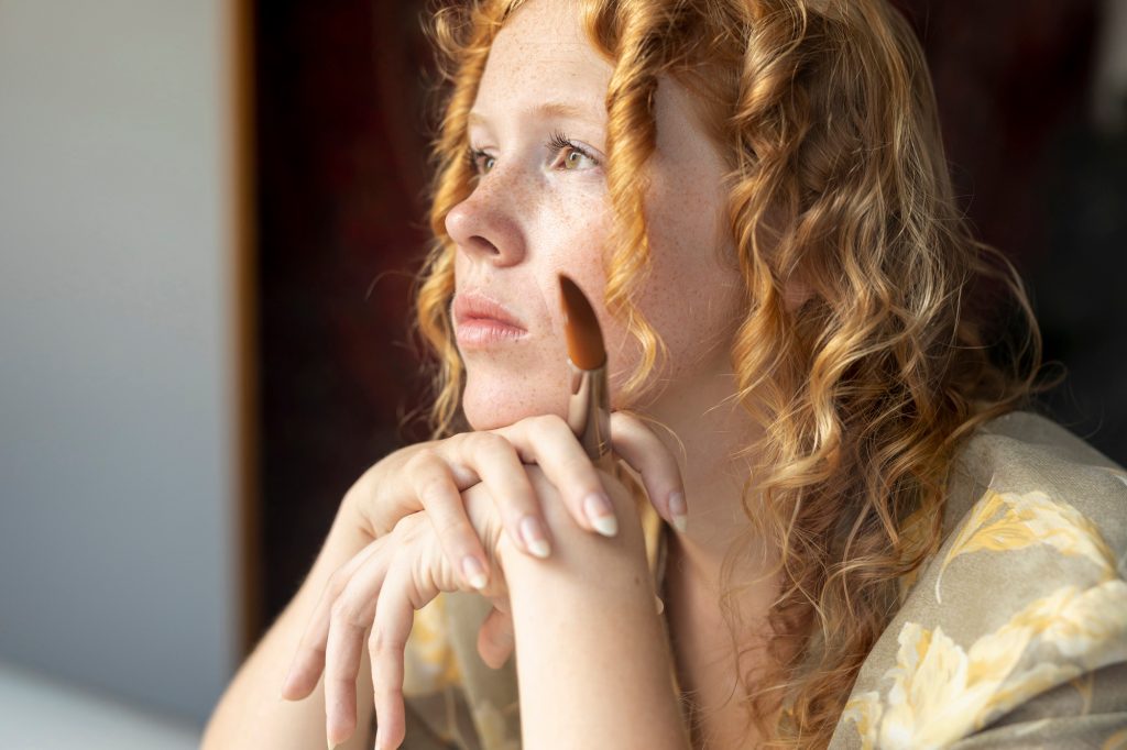 Close up woman with ginger hair in deep thoughts Image by freepik