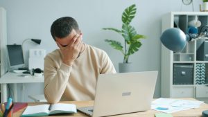 frustrated gent sat by laptop Image by Vitaly Gariev on pexels
